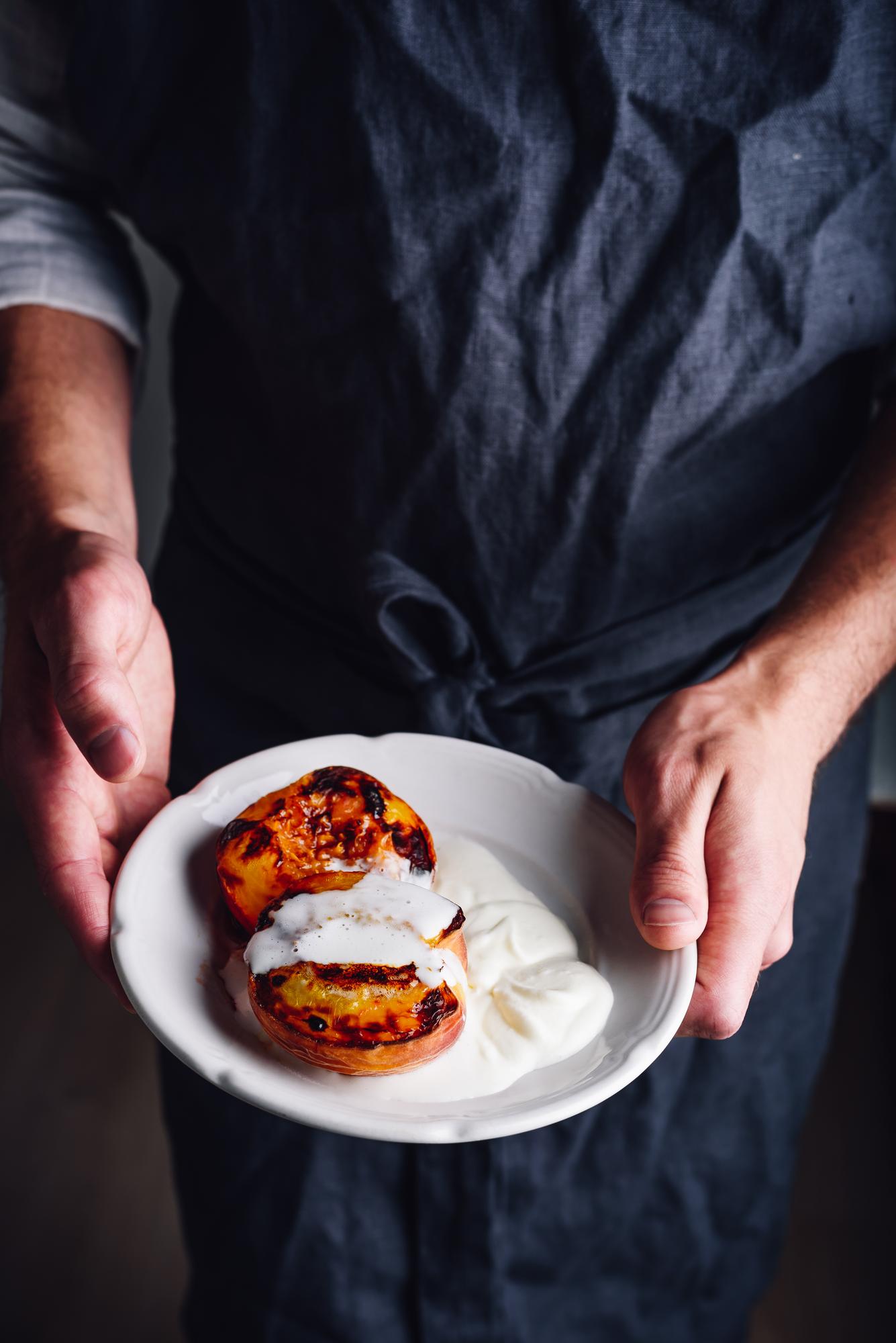 Hands plating a gourmet dish
